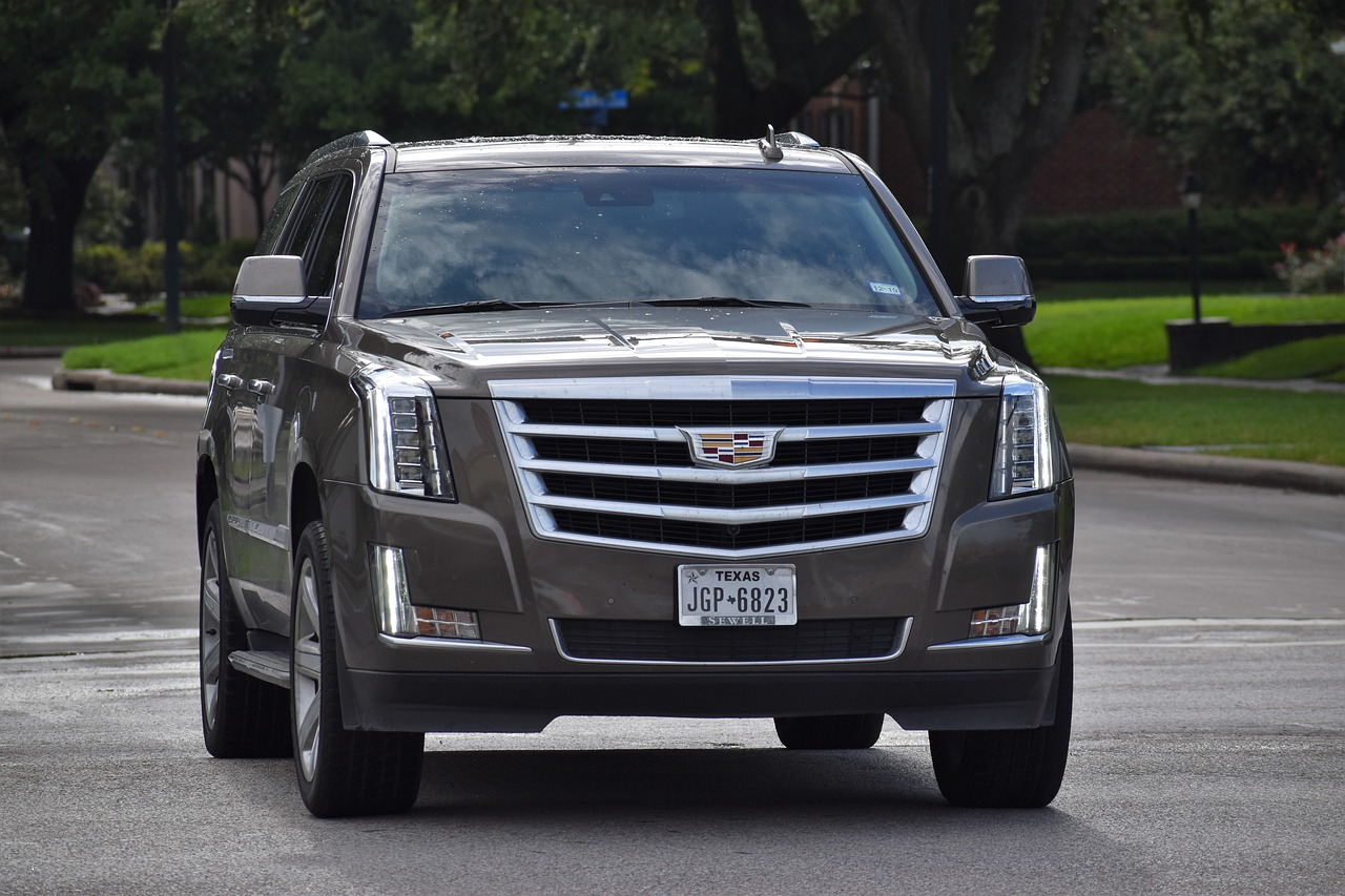 A gray-colored Cadillac Escalade on a road