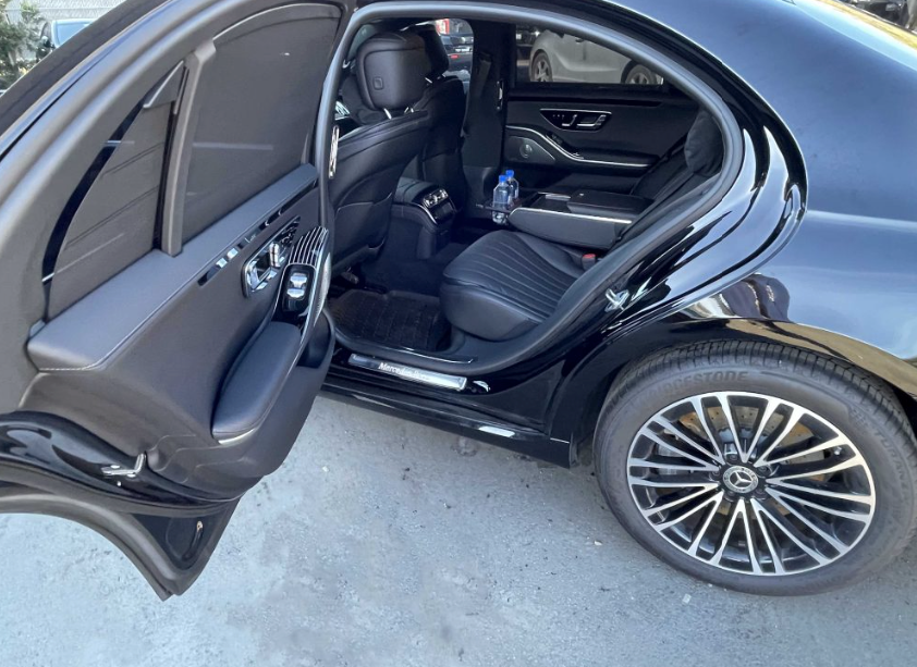 A sedan with the door open, showing the comfort offered during an airport transfer.
