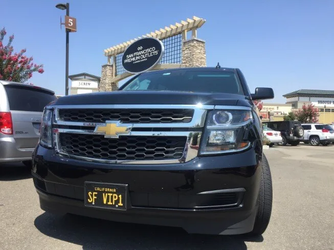 Black Chevrolet Suburban with SF VIP plate at San Francisco Premium Outlets
