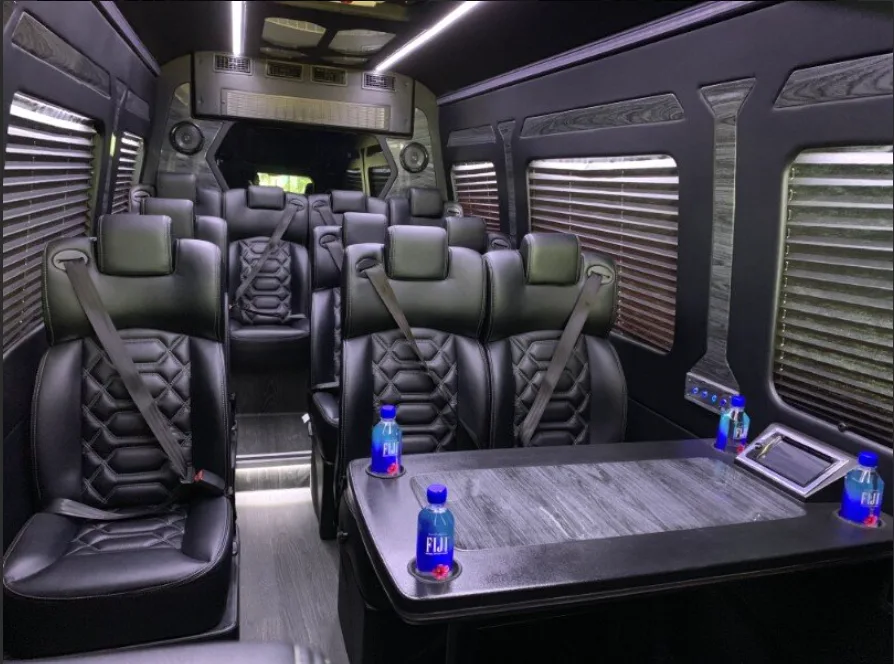 Executive van interior with black leather seats and a center table