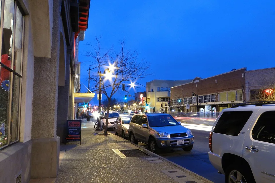 Downtown Petaluma street with parked cars at dusk