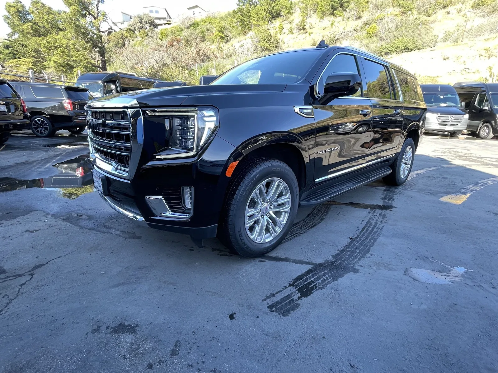 Black GMC Yukon SUV parked on a sunny lot