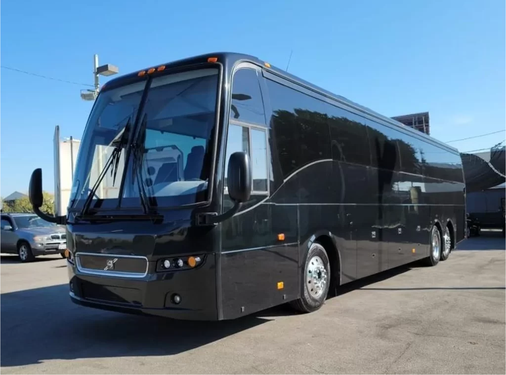Black motorcoach limousine bus parked in a lot
