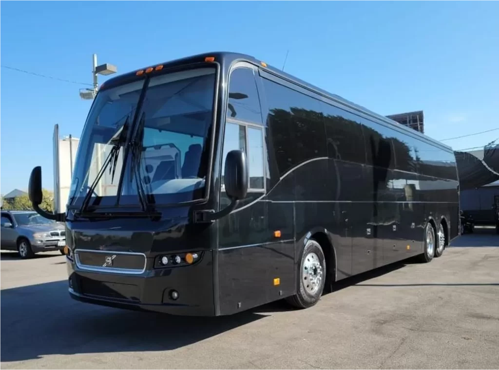 Black Volvo 9700 motorcoach parked in a lot