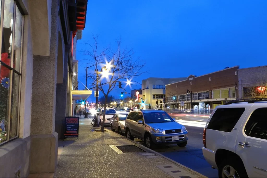Downtown Petaluma street with shops and parked cars at dusk