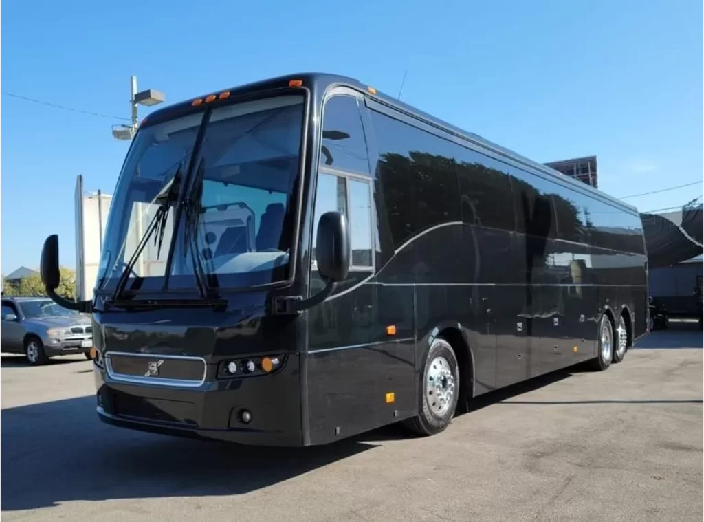 Black Volvo 9700 motorcoach parked on a sunny day