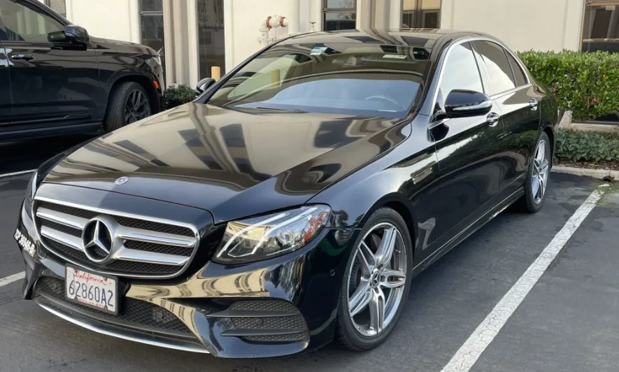 A Mercedes-Benz E300 parked near a building