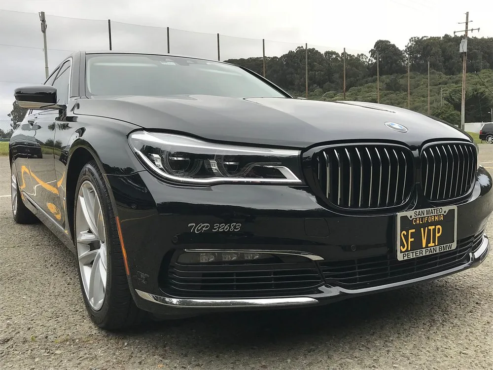 Front view of a black BMW 7 Series sedan with SF VIP plate