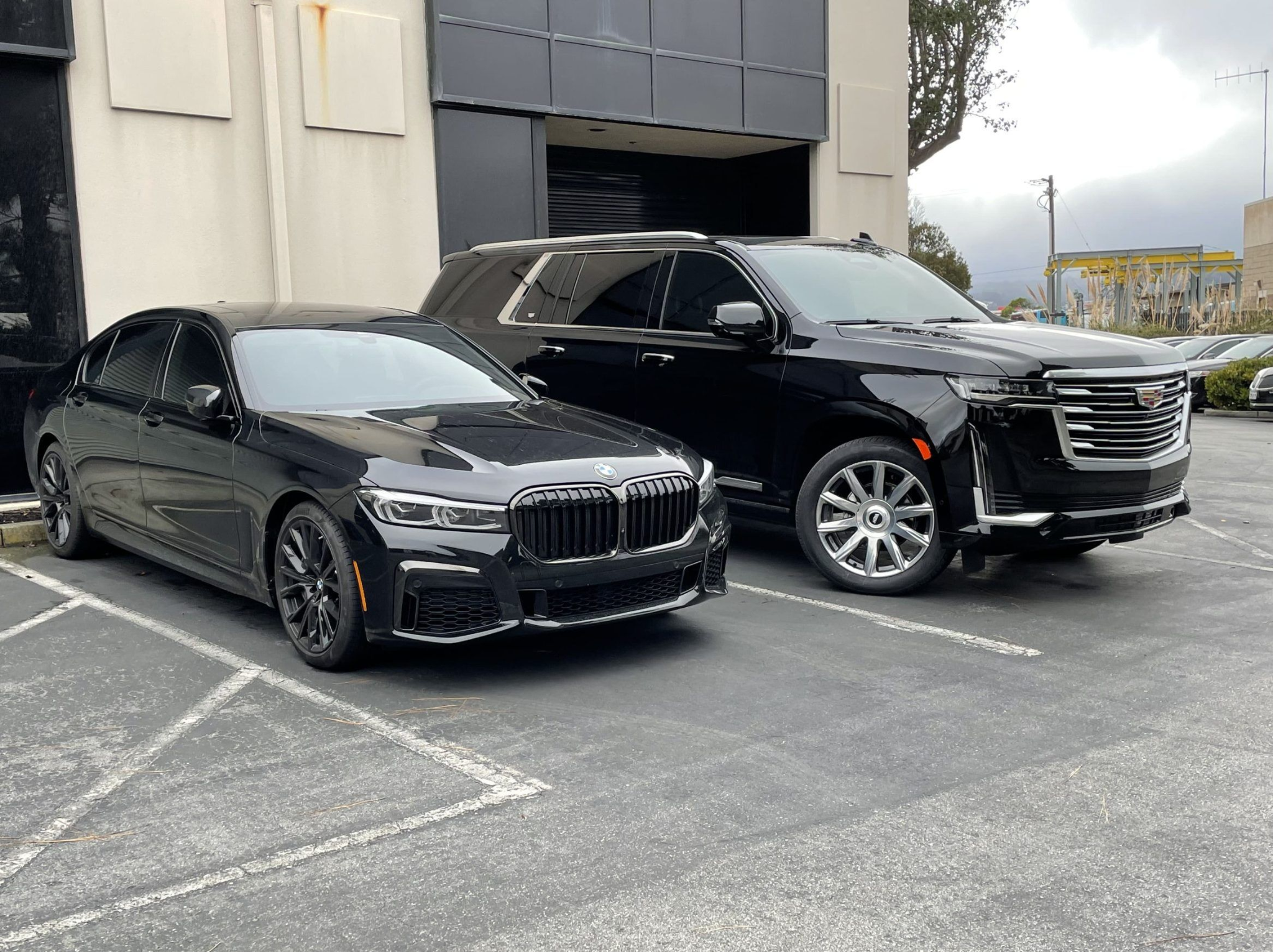 BMW sedan and Cadillac Escalade parked side by side, two Limo SF VIP options for the SFO to Menlo Park ride.