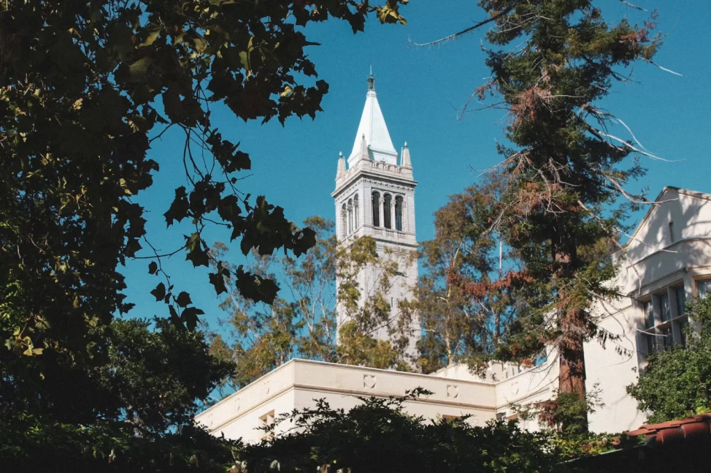 Sather Tower clock tower at UC Berkeley framed by trees