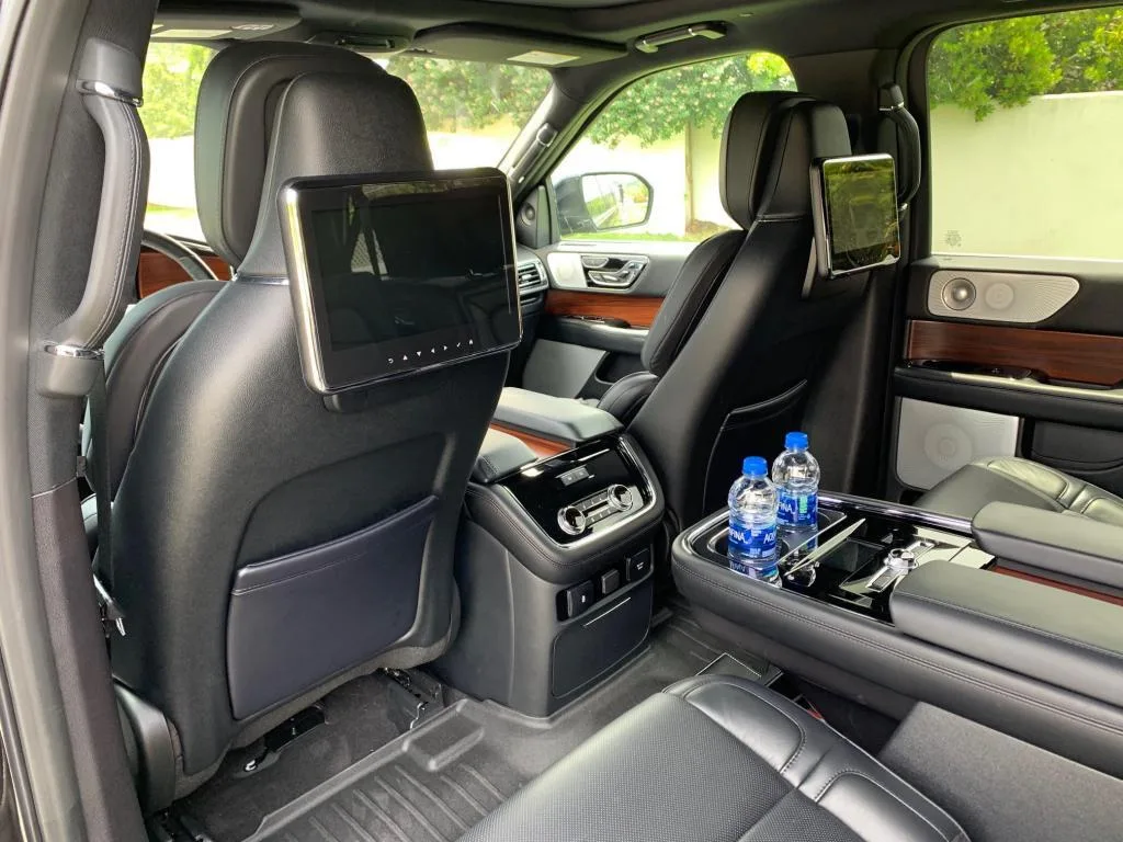 Lincoln Navigator rear seats with headrest screens and bottled water