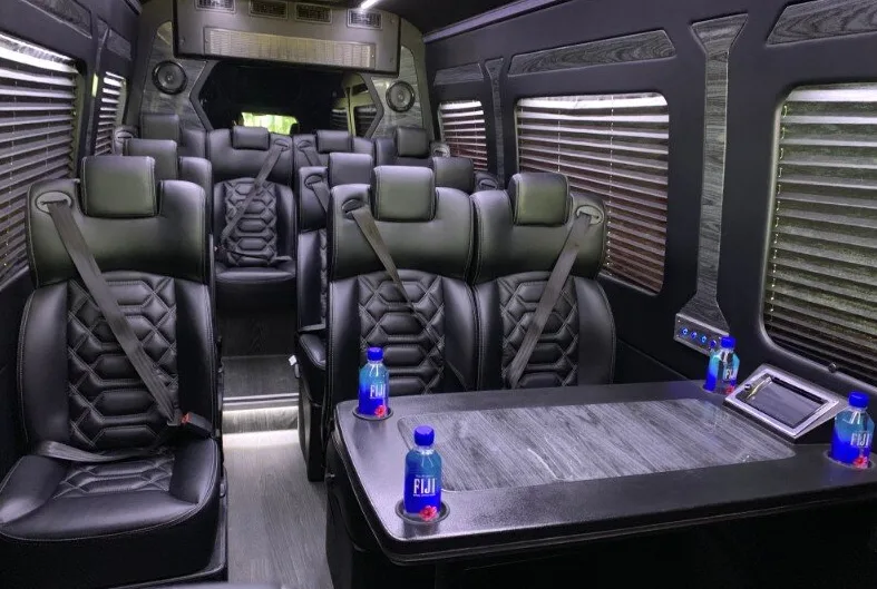 Executive Sprinter van interior with leather seats and a table for a Napa wine tour