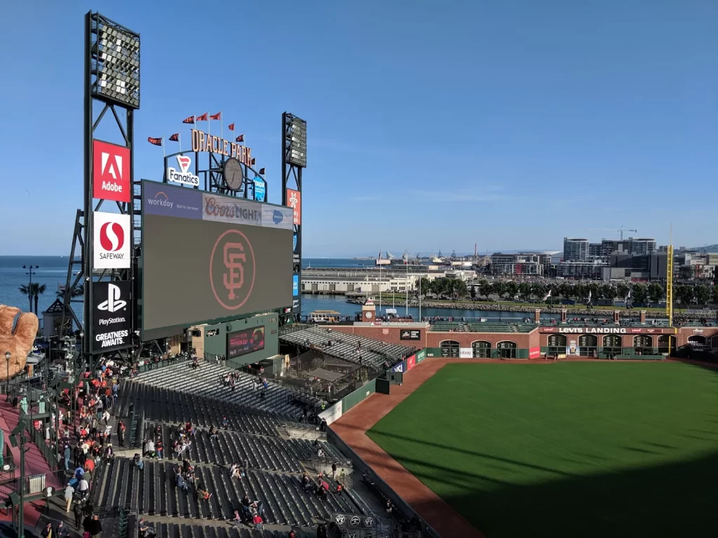 View of Oracle Park ballpark with scoreboard and the bay behind