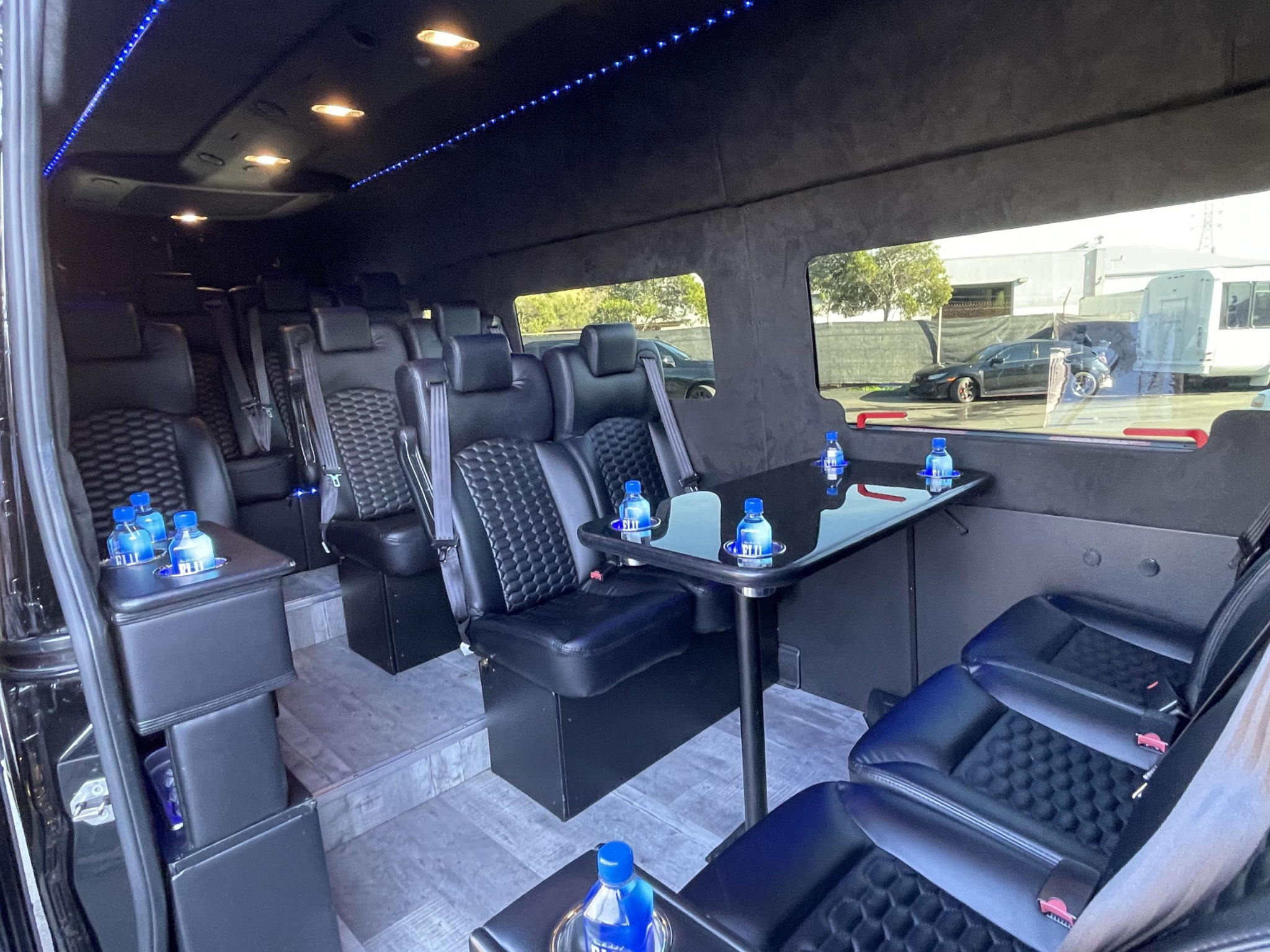 Sprinter van interior with leather seating and a table, the larger vehicle option on the SFO to Menlo Park route. 
