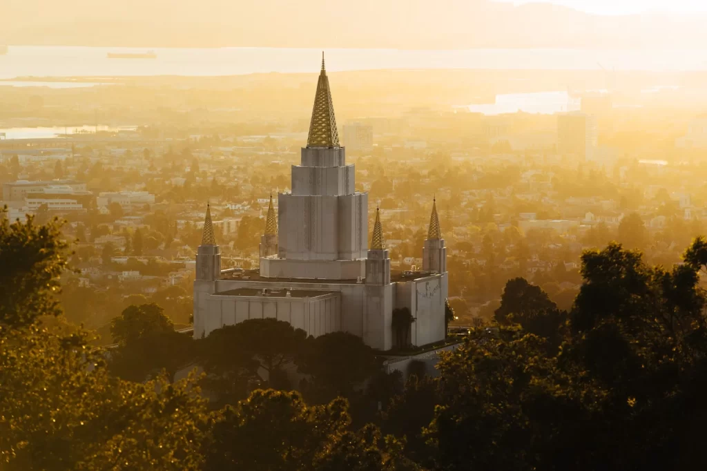 Oakland California Temple spires at sunset over the hills