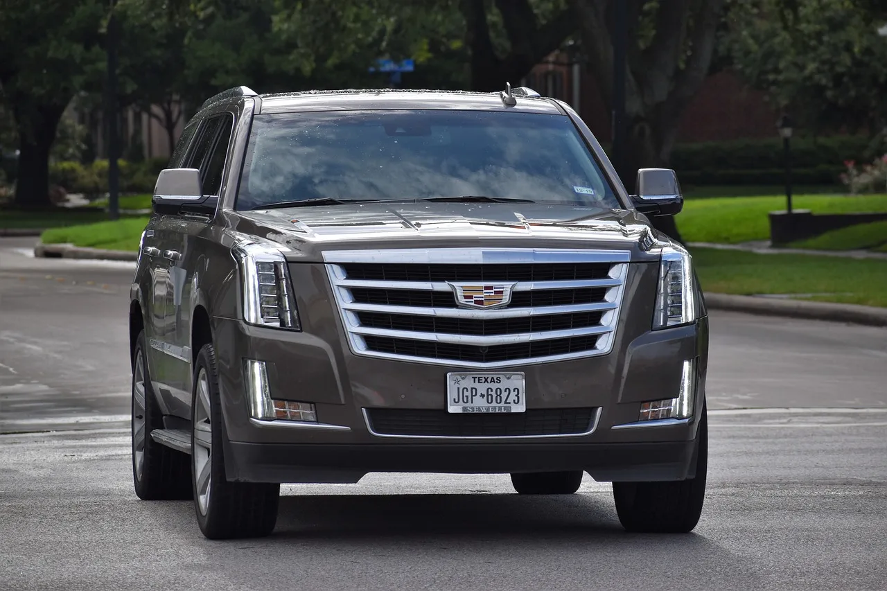 A gray-colored Cadillac Escalade on a road