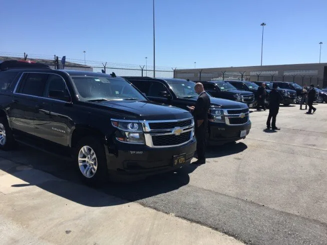 Black Chevrolet Suburban SUVs lined up in a parking lot