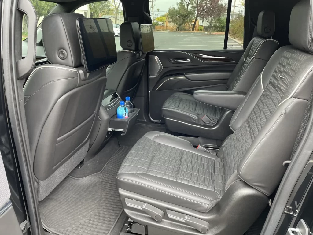 Second-row leather captain's chairs inside a black premium SUV