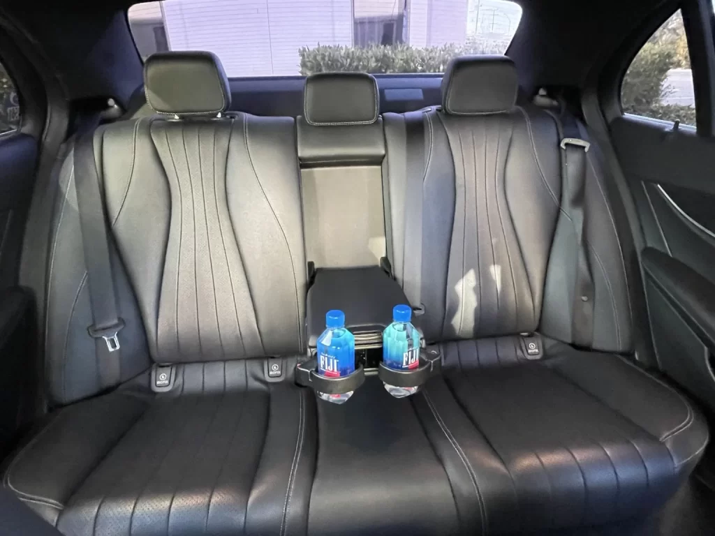 The interior of the Mercedes-Benz E300 with bottled water. 