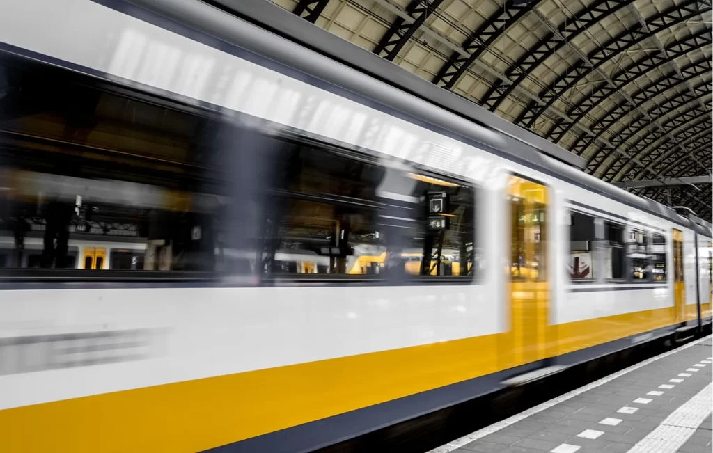 Train pulling out of a covered rail station